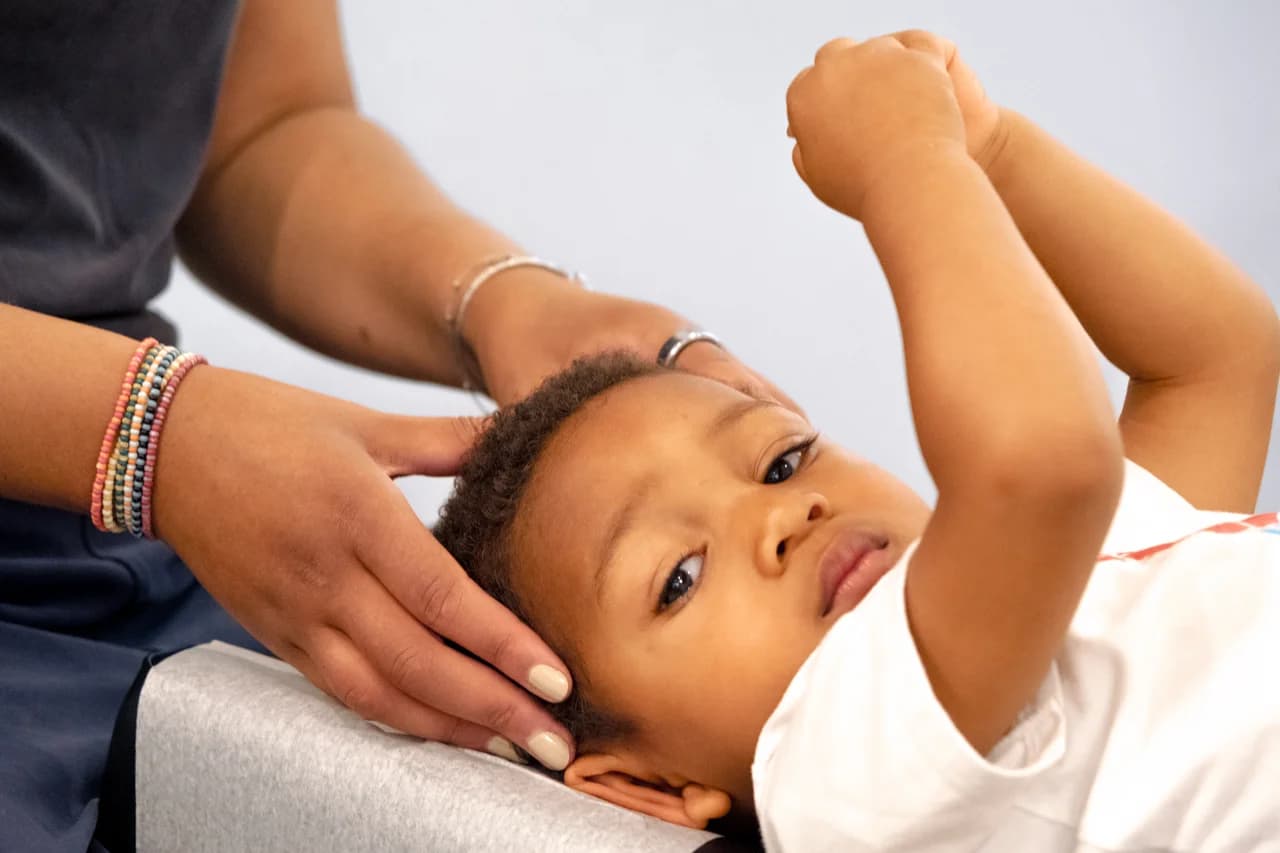 Baby receiving gentle chiropractic care